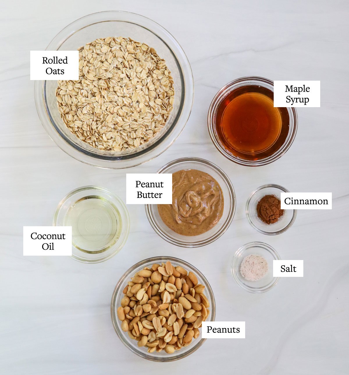 peanut butter granola ingredients in glass bowls.