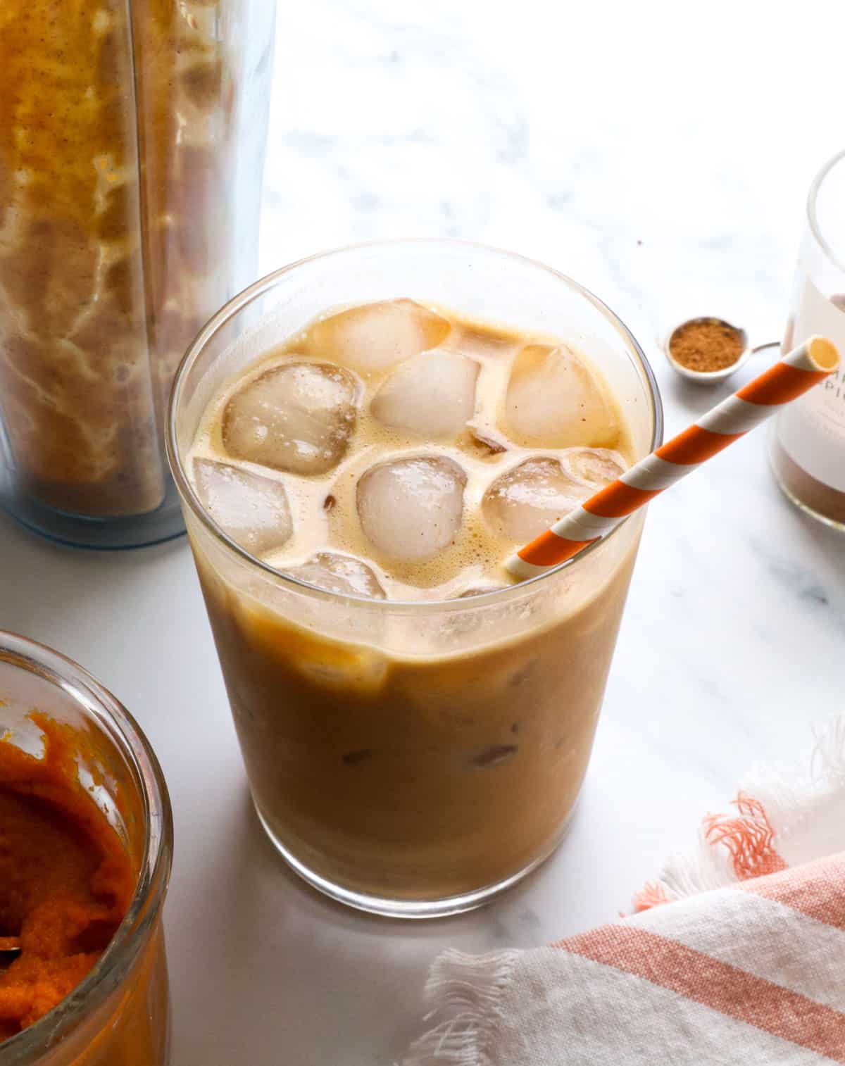 pumpkin creamer stirred into a glass of iced coffee.