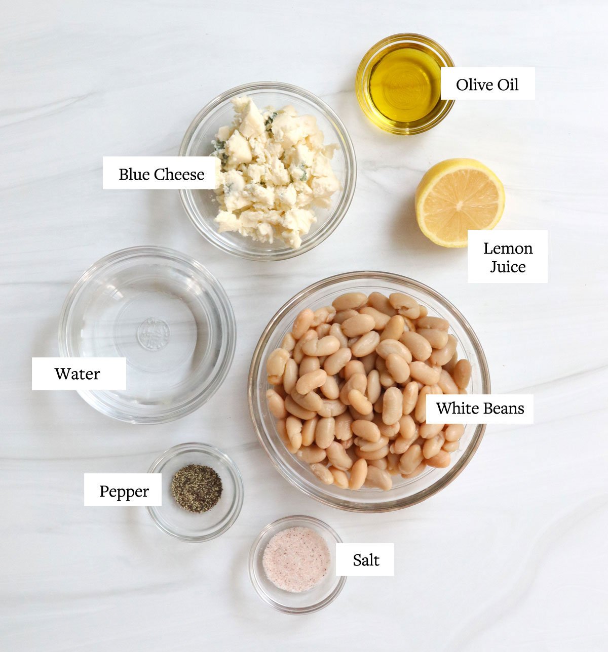 blue cheese dressing ingredients labeled in glass bowls.