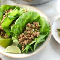 vegetarian lettuce wraps served with lime wedges.