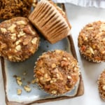 healthy apple muffins on blue plate with crushed walnuts.