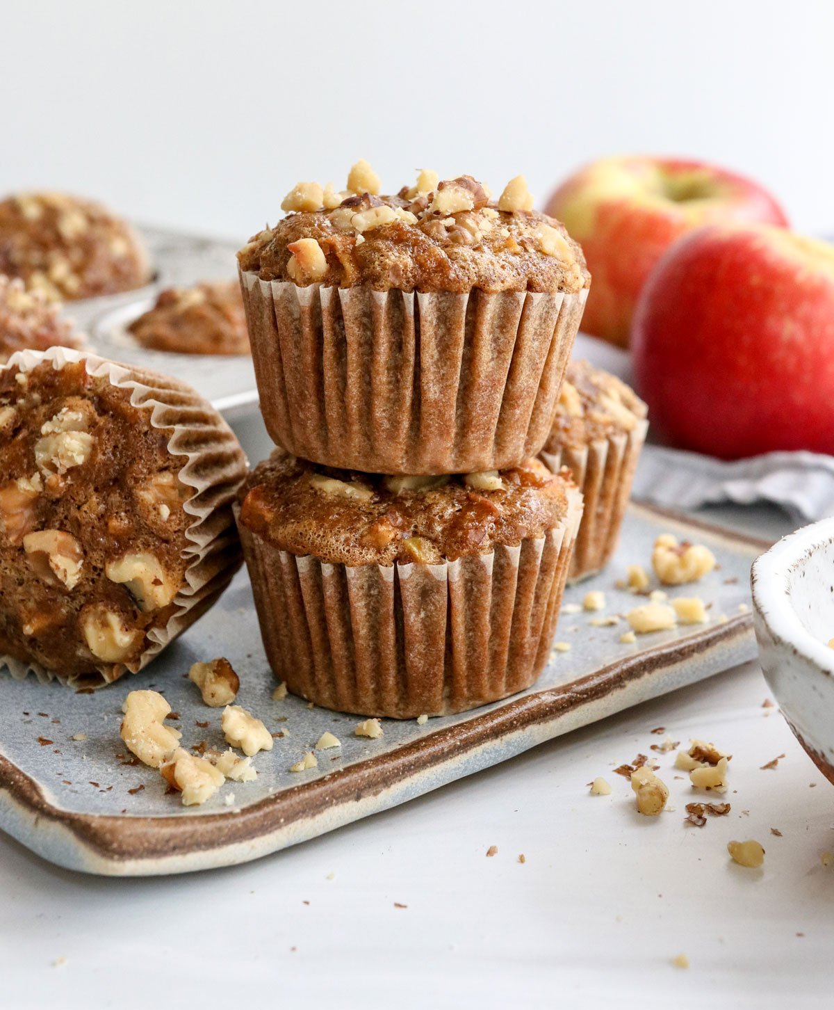 apple muffins stacked on blue plate.