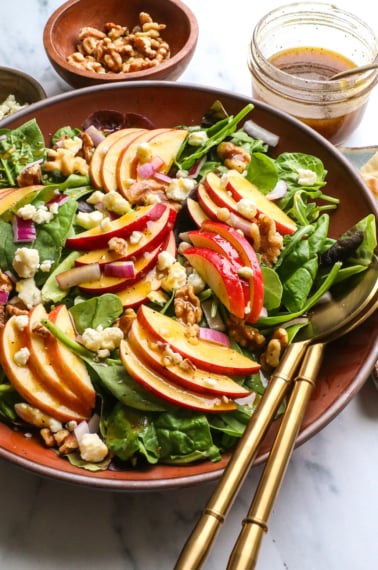 salad finished with dressing, walnuts, and blue cheese.