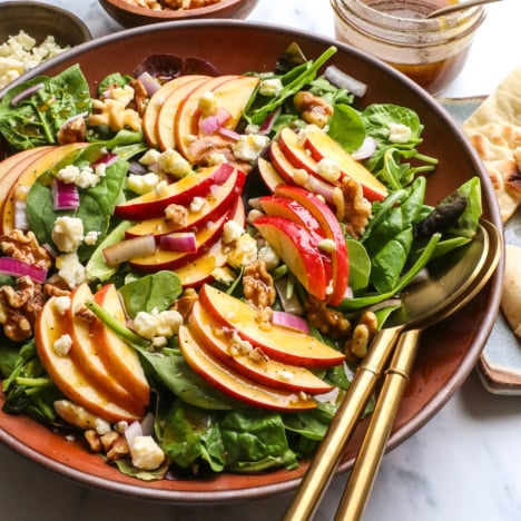 salad finished with dressing, walnuts, and blue cheese.