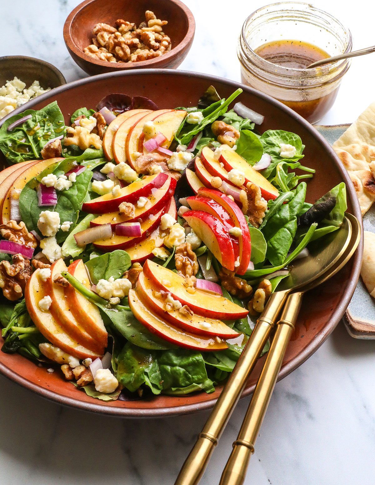 salad finished with dressing, walnuts, and blue cheese.