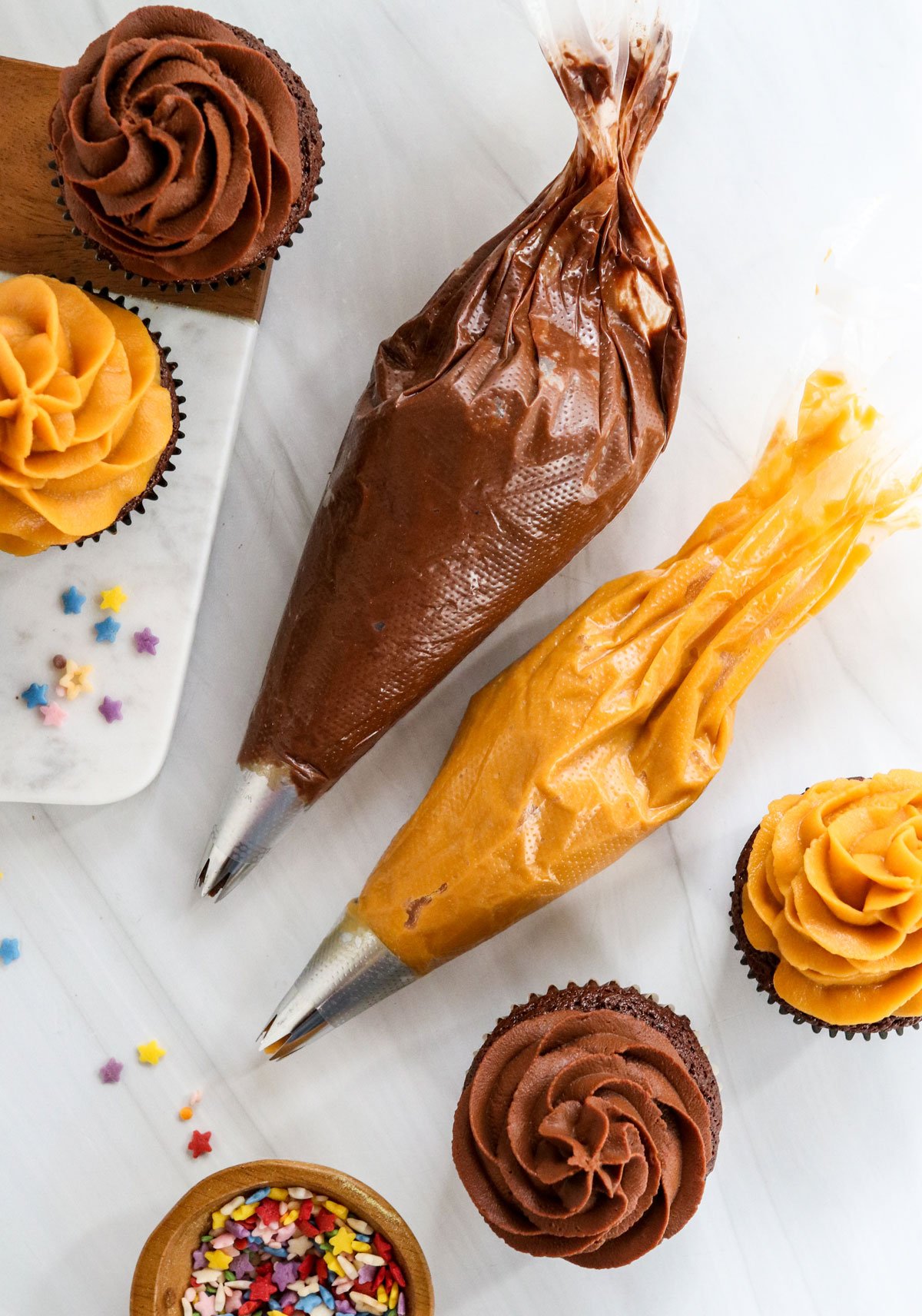 chocolate and orange sweet potato frosting in piping bags.