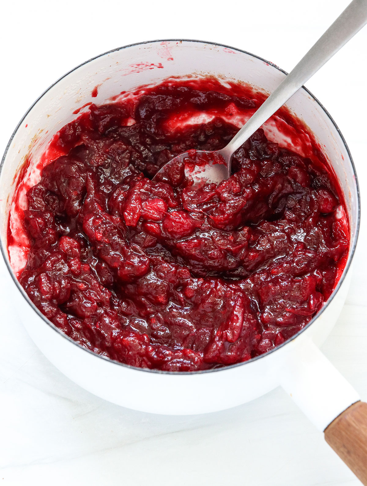 cooked cranberry sauce in white saucepan.