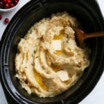 mashed potatoes served in slow cooker with butter on top.