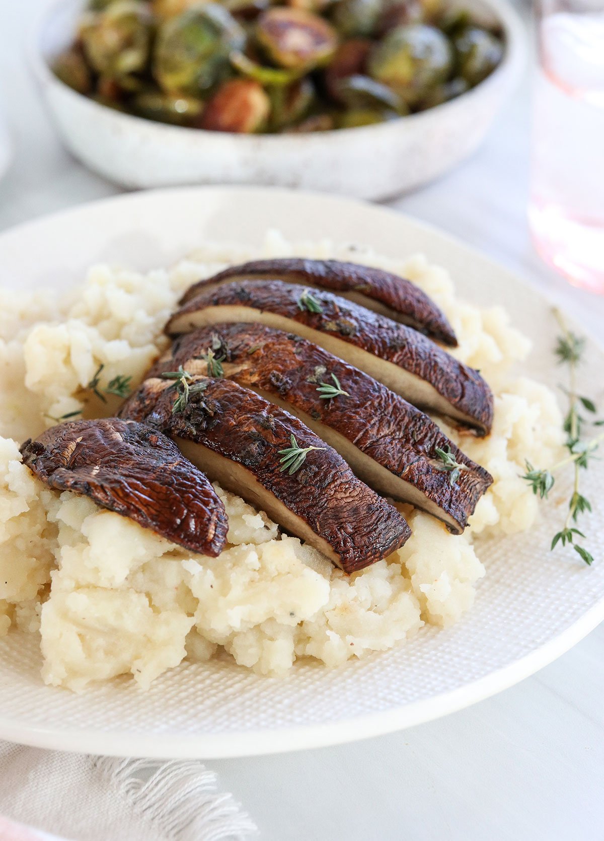 sliced mushrooms served on mashed potatoes.