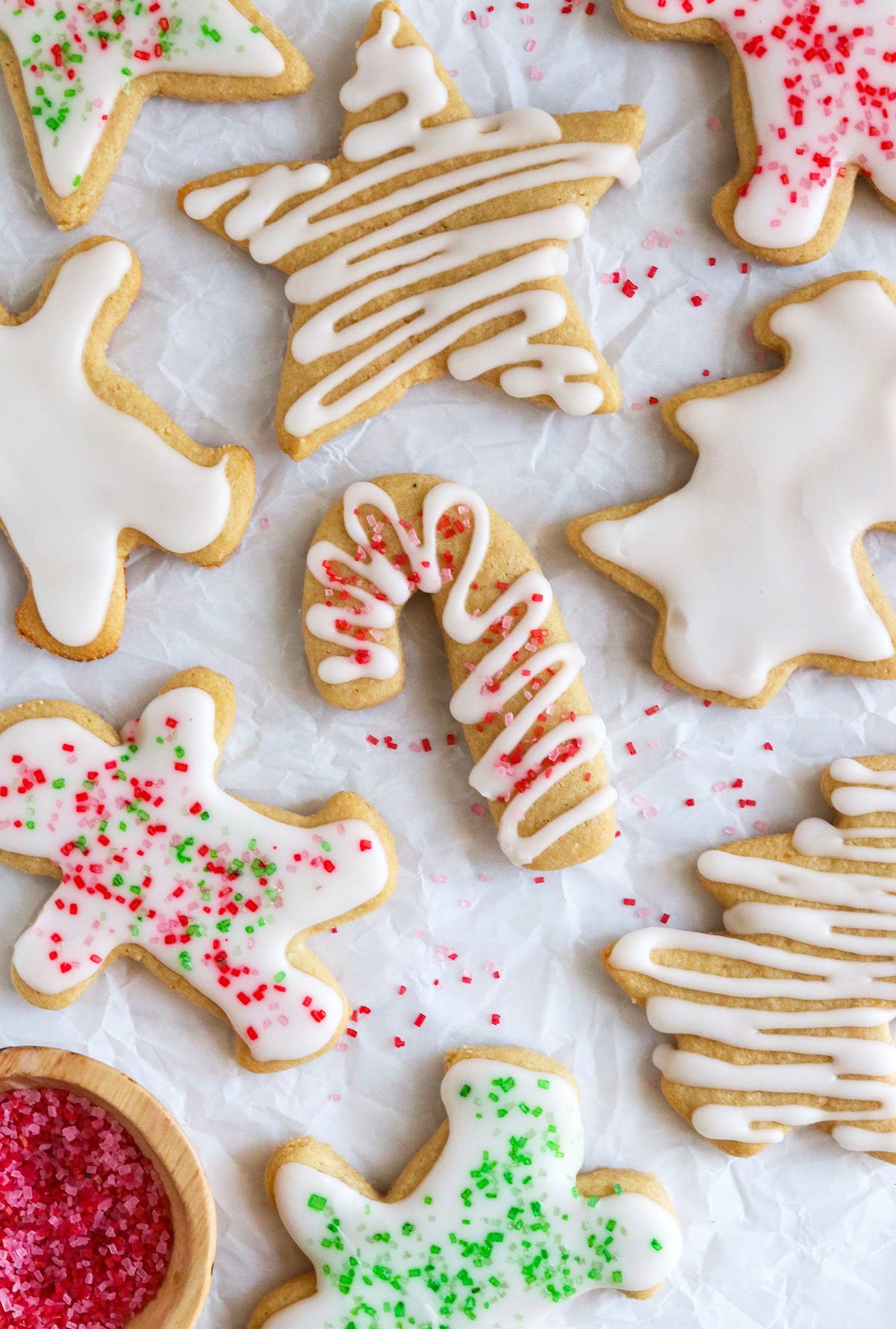 frosted almond flour sugar cookies with sugar on top.