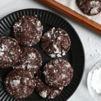 gluten free chocolate cookies on a black plate.
