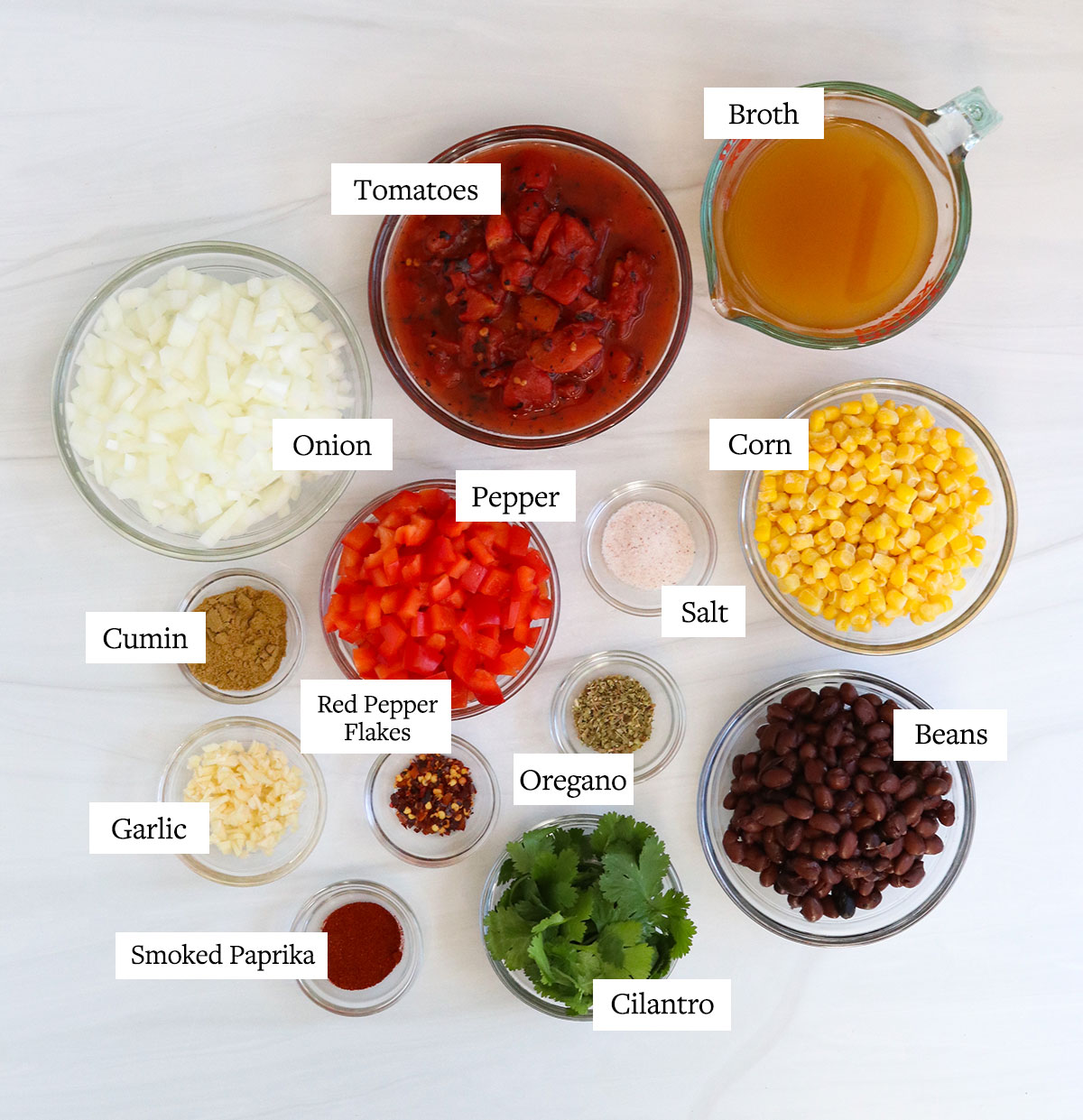 tortilla soup ingredients labeled in glass bowls.