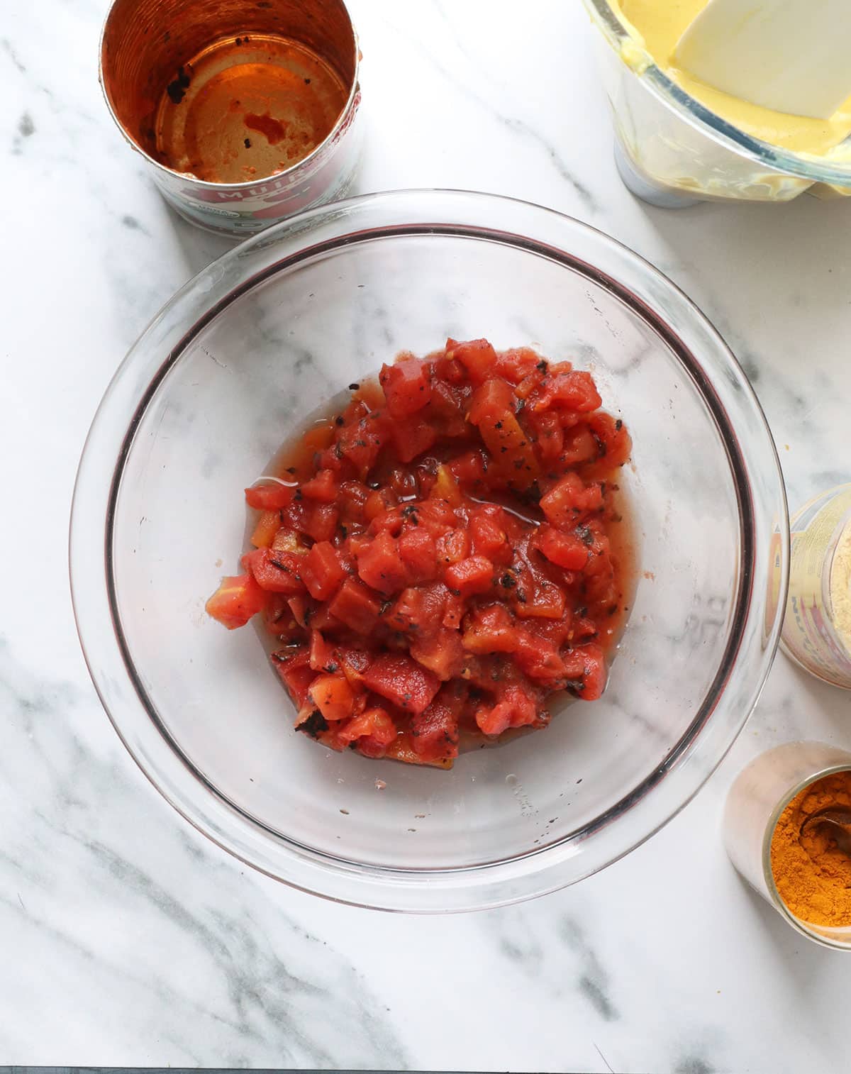 diced tomatoes in a glass bowl for queso dip.