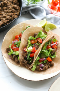 3 healthy ground beef tacos on a serving plate.