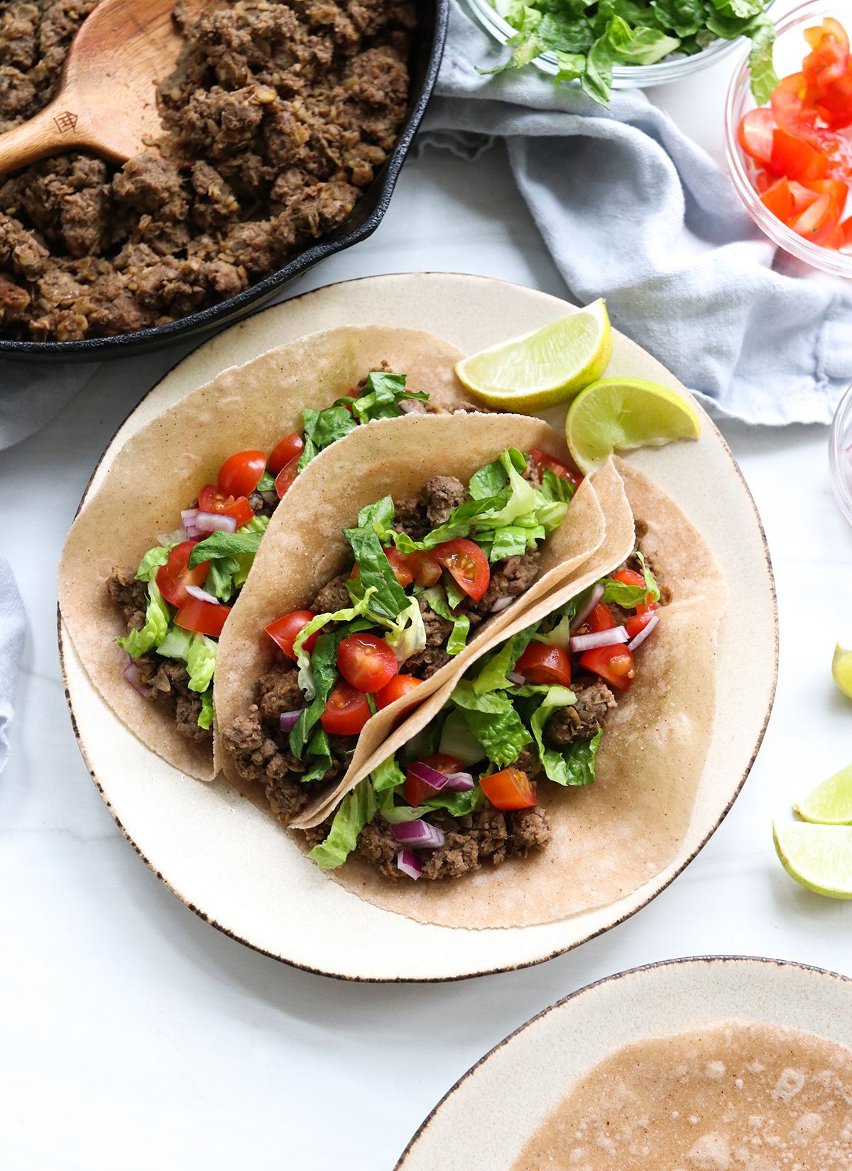 healthy tacos overhead on a plate with topping options.