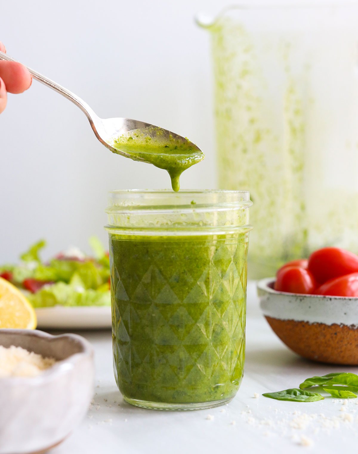 basil pesto salad dressing stored in a mason jar.