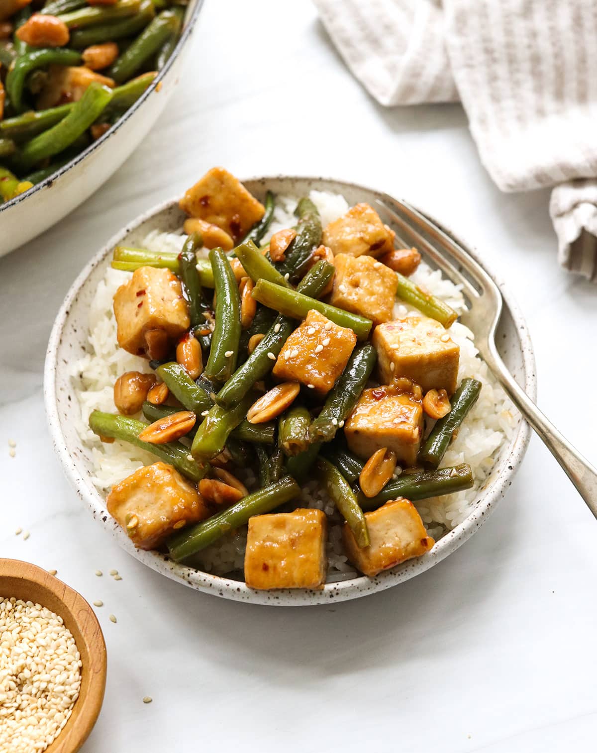 kung pao tofu with green beans served over rice.
