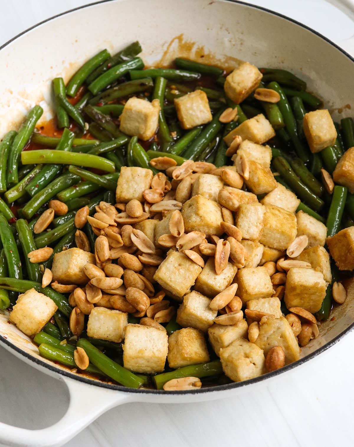 baked tofu and peanuts added to the pan of green beans.