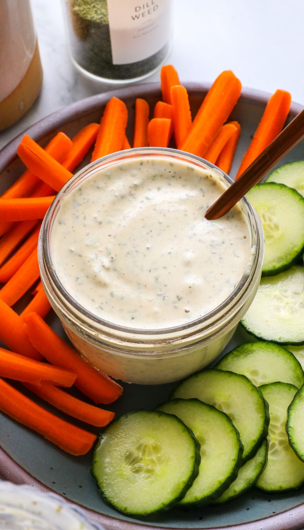 vegan ranch dressing stirred with a spoon.
