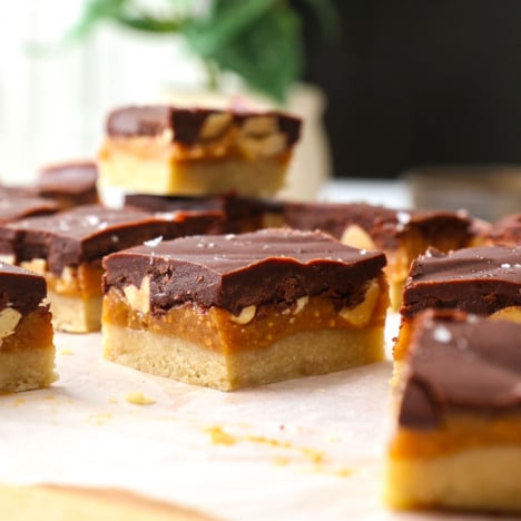 Close-up of a healthy snickers bar to show the layers of caramel, chocolate, and peanuts.