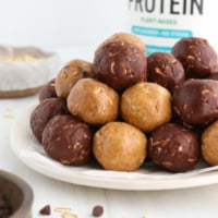 protein balls in 3 flavors stacked on white plate.