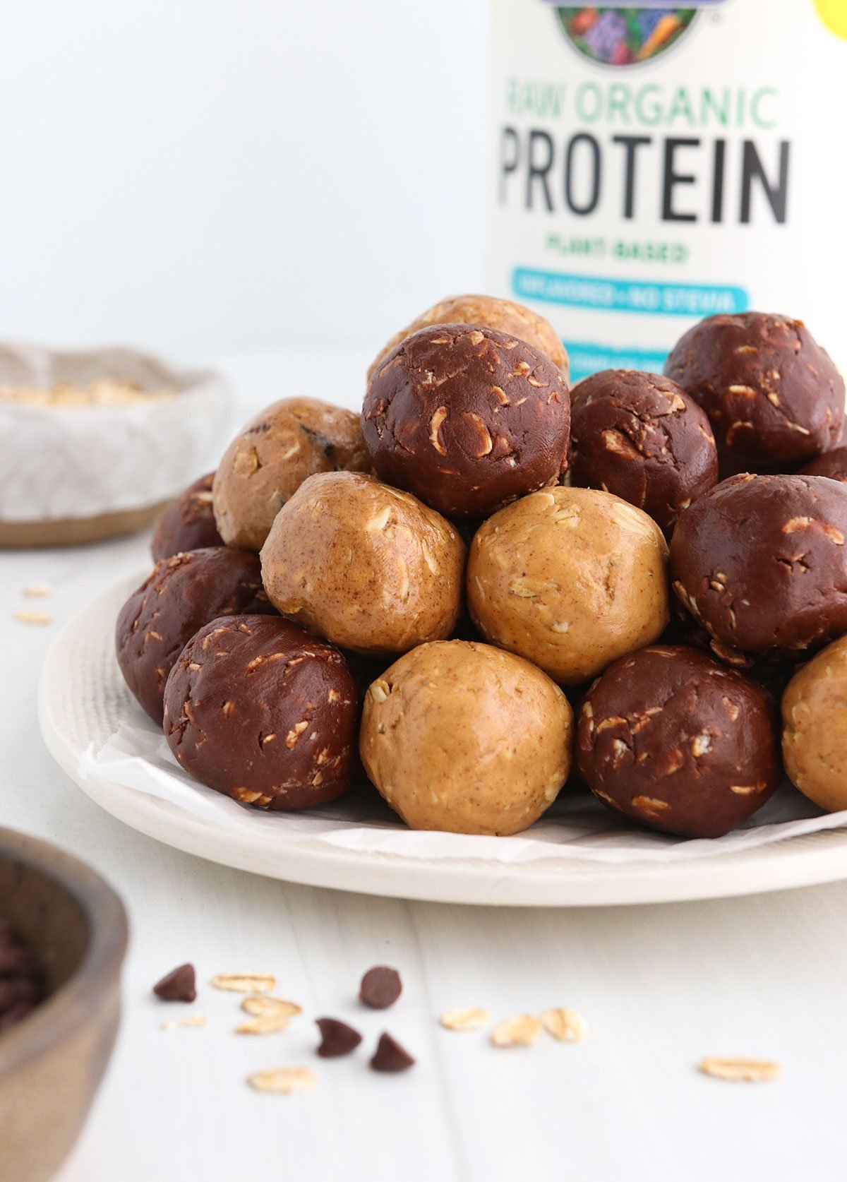 protein balls in 3 flavors stacked on white plate.