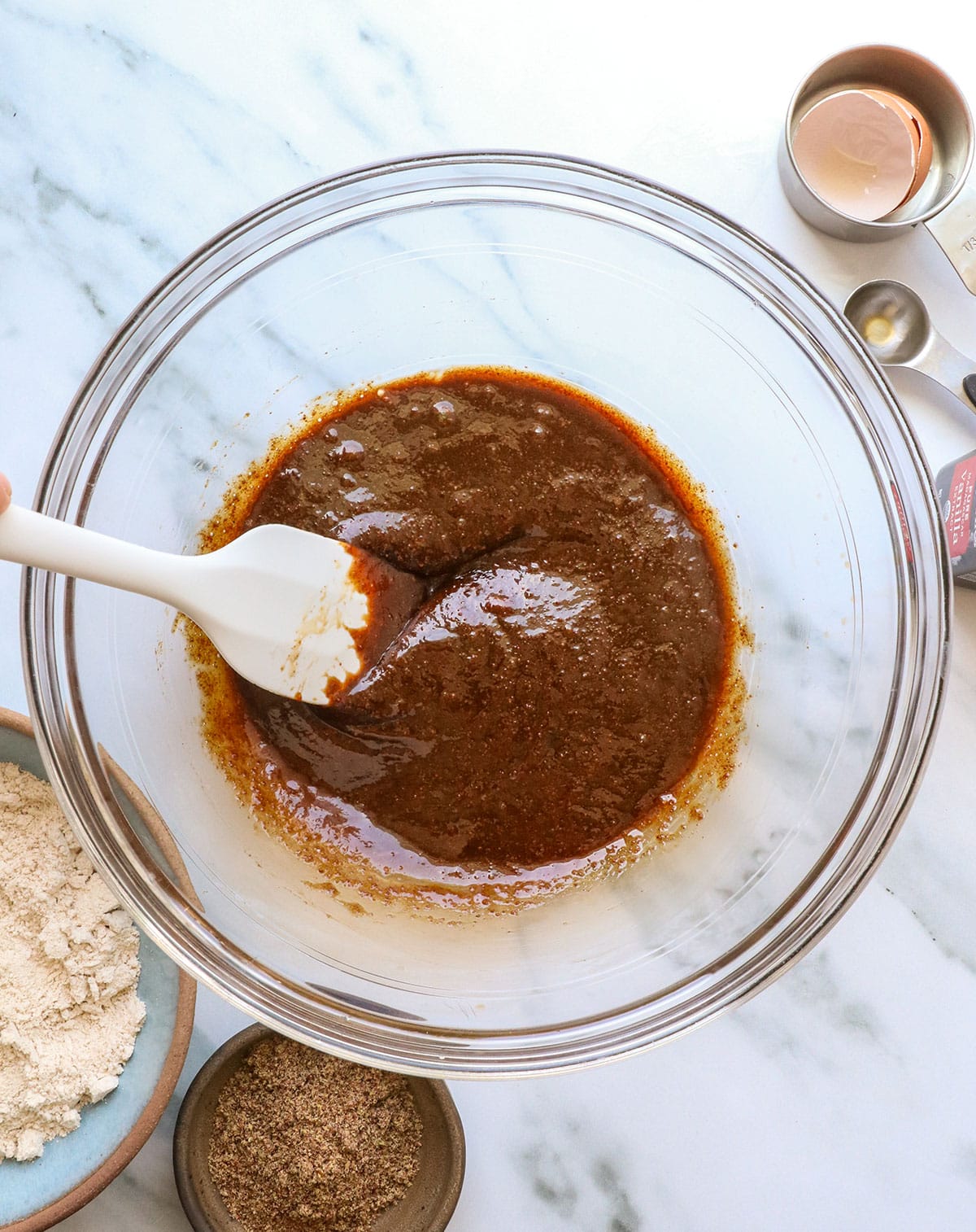 coconut sugar mixed with egg and coconut oil in a bowl.