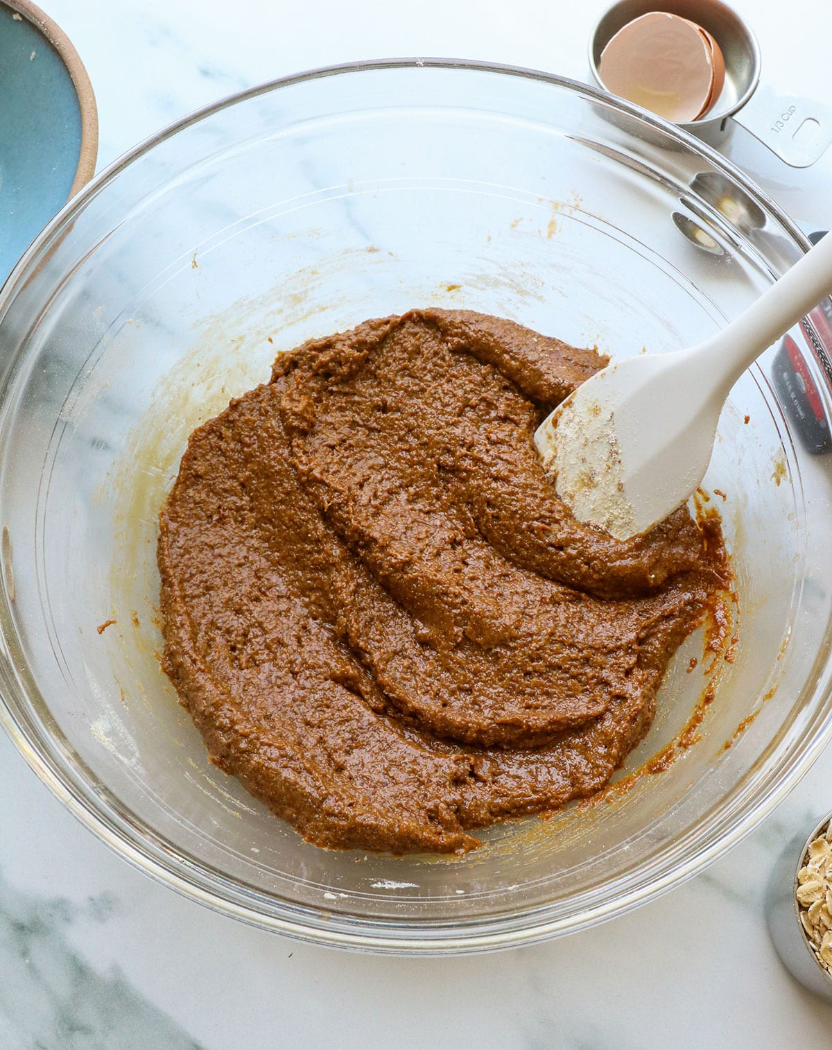 Lactation cookie dough mixed until smooth in a glass bowl.