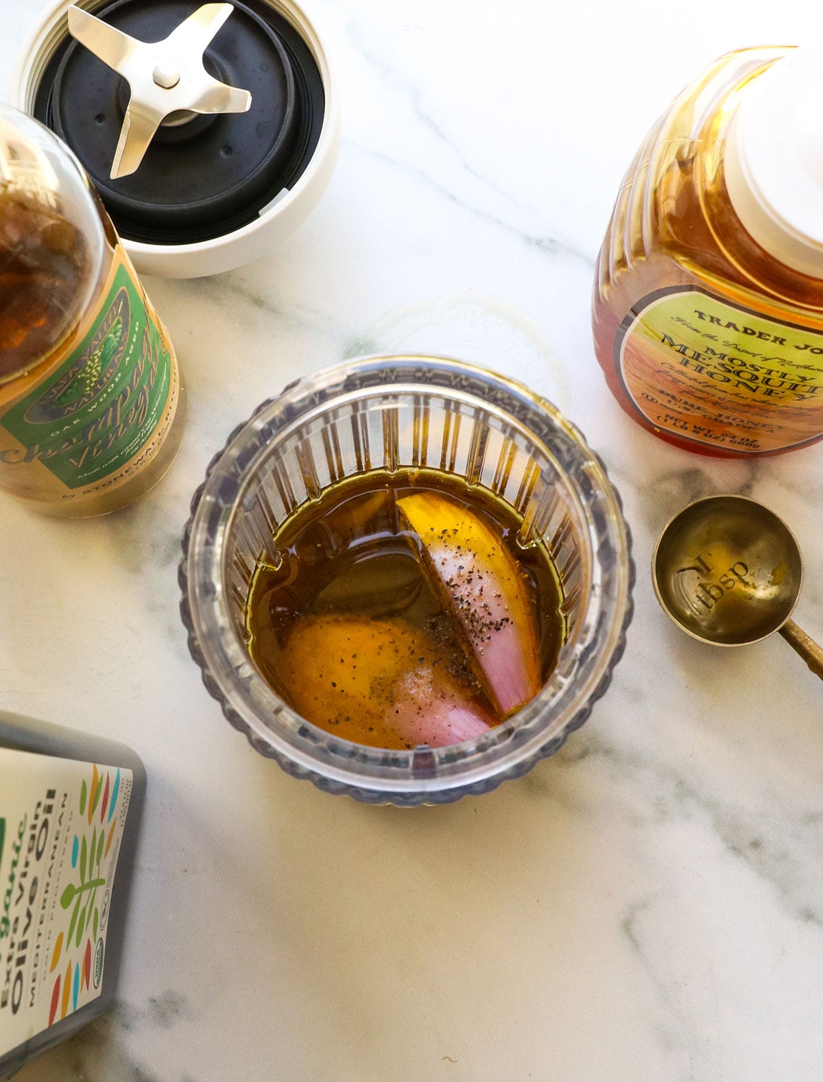 olive oil, vinegar, honey, shallot, and seasonings added to blender for champagne vinaigrette.