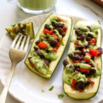 stuffed zucchini with black beans and a dairy-free cilantro sauce.