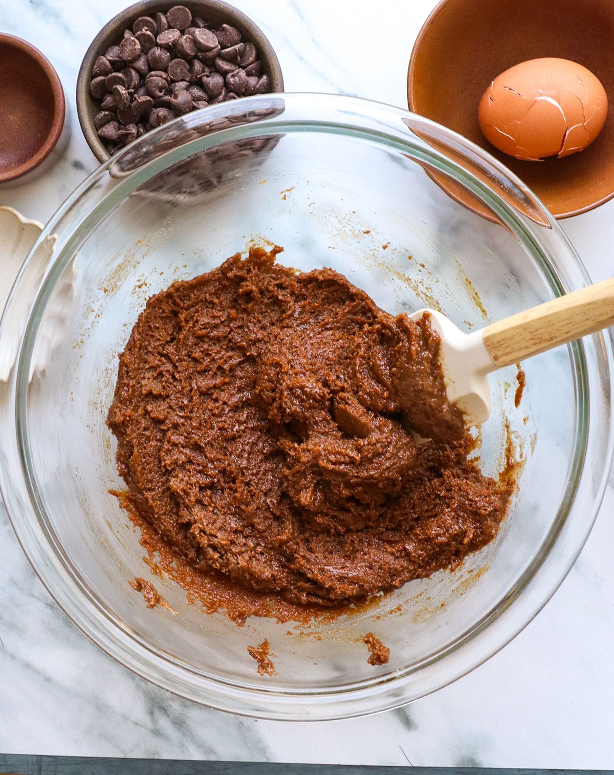 almond butter cookie dough mixed with a spatula in the bowl.