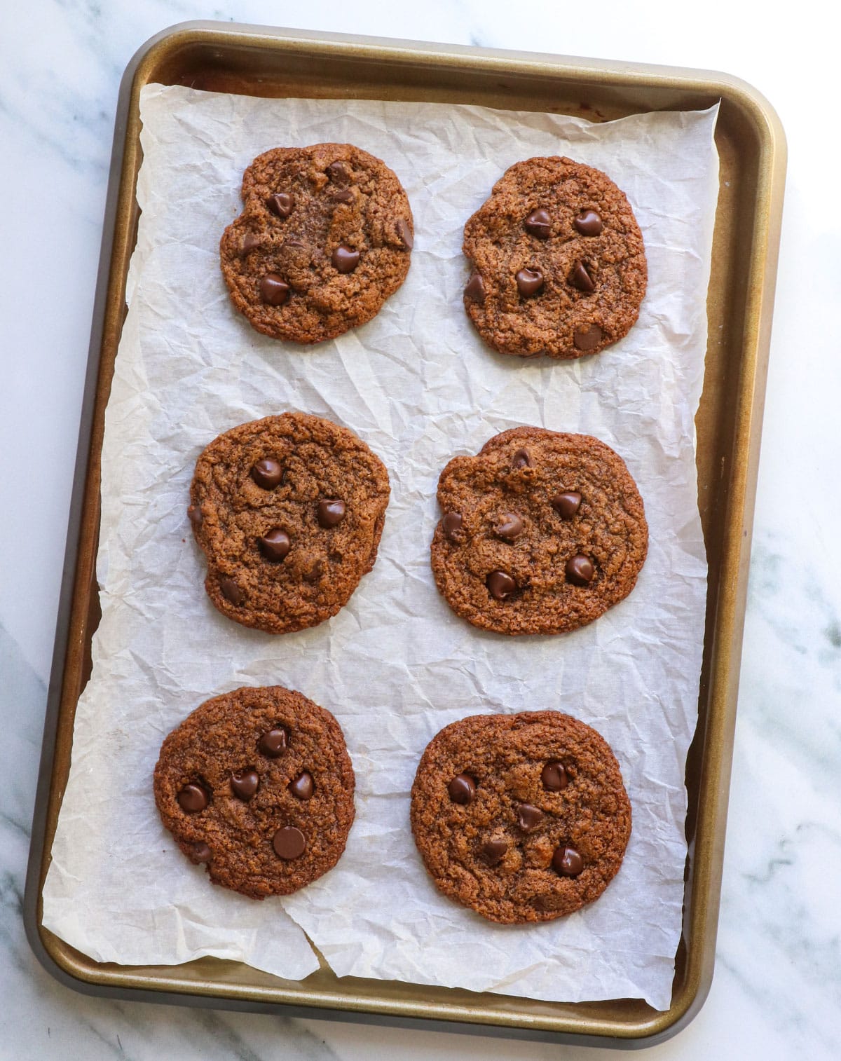 almond butter cookies cooling on the pan after baking.