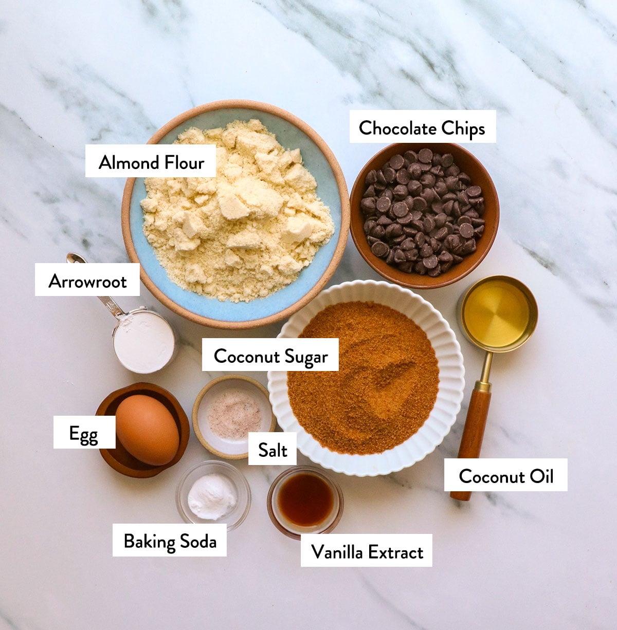 almond flour, coconut sugar, egg, arrowroot starch, and chocolate chips labeled in bowls.