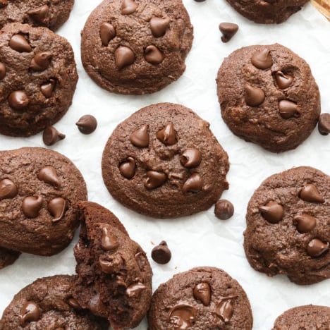 Chocolate Buckwheat Cookies cooling on a lined sheet pan.