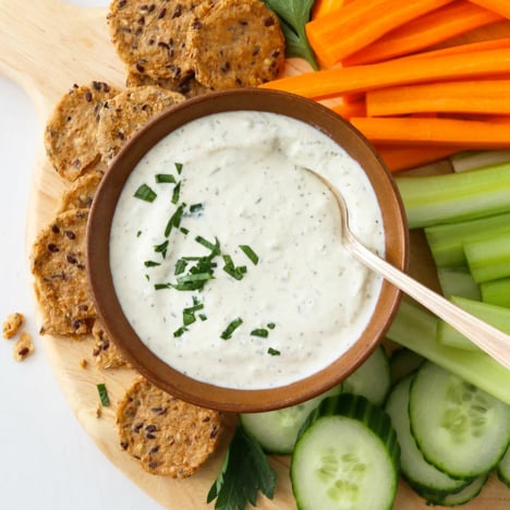 cottage cheese dip in a bowl served with crackers and veggies.