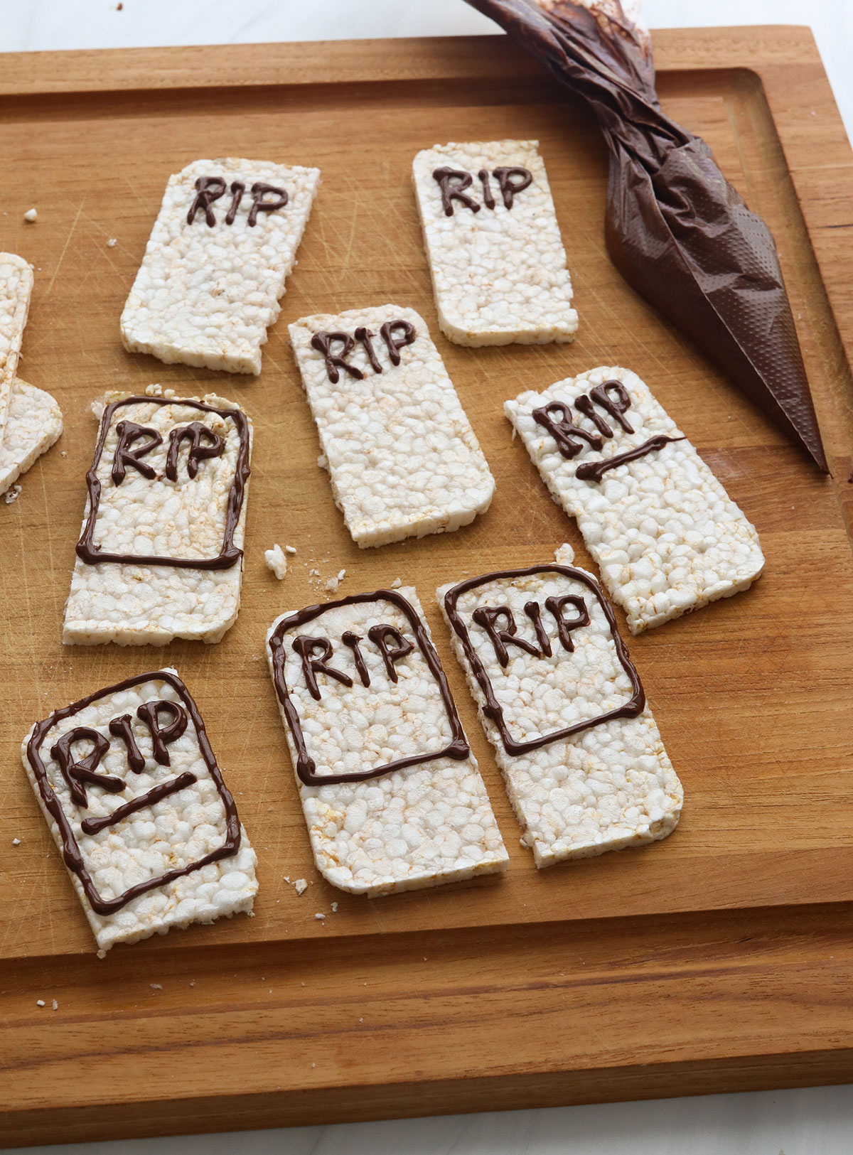 melted chocolate added to rice crackers to look like tombstones.