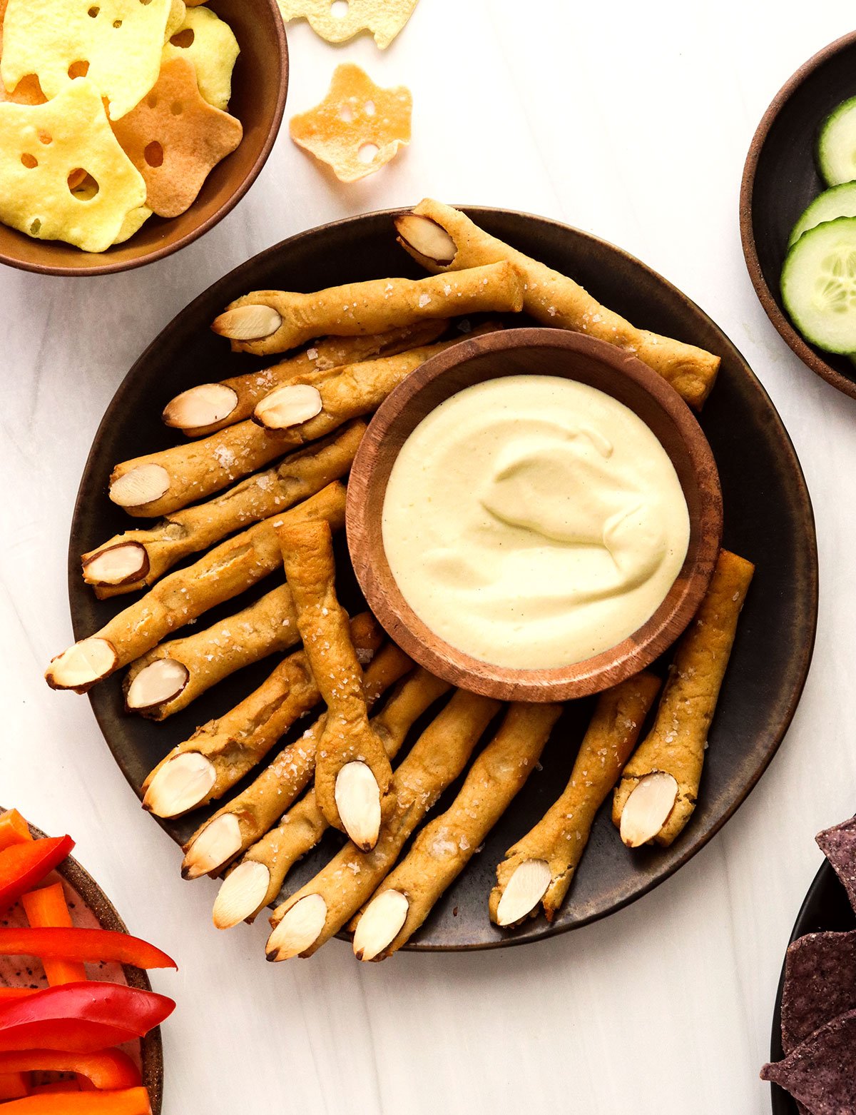 pretzel witch fingers served with cheese dip.