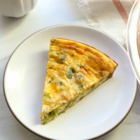 slice of crustless quiche on a white plate.