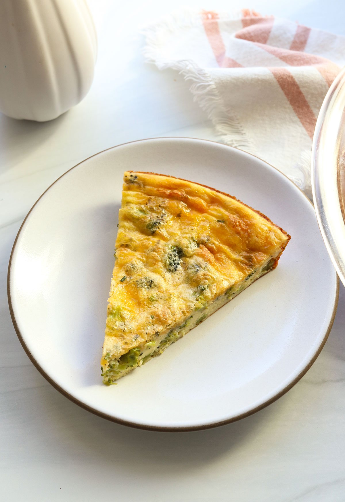 slice of crustless quiche on a white plate.