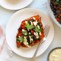 sweet potato stuffed with black beans and topped with cashew cheese sauce.