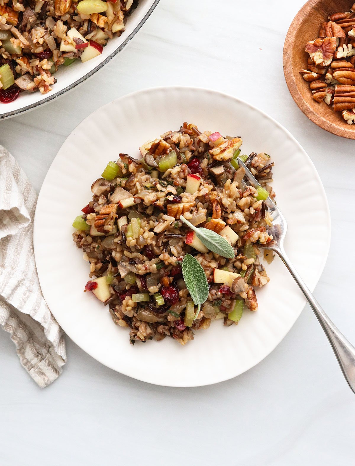 wild rice stuffing served on a white plate with a fork.