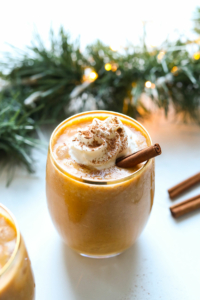Vegan eggnog topped with whipped cream and cinnamon.
