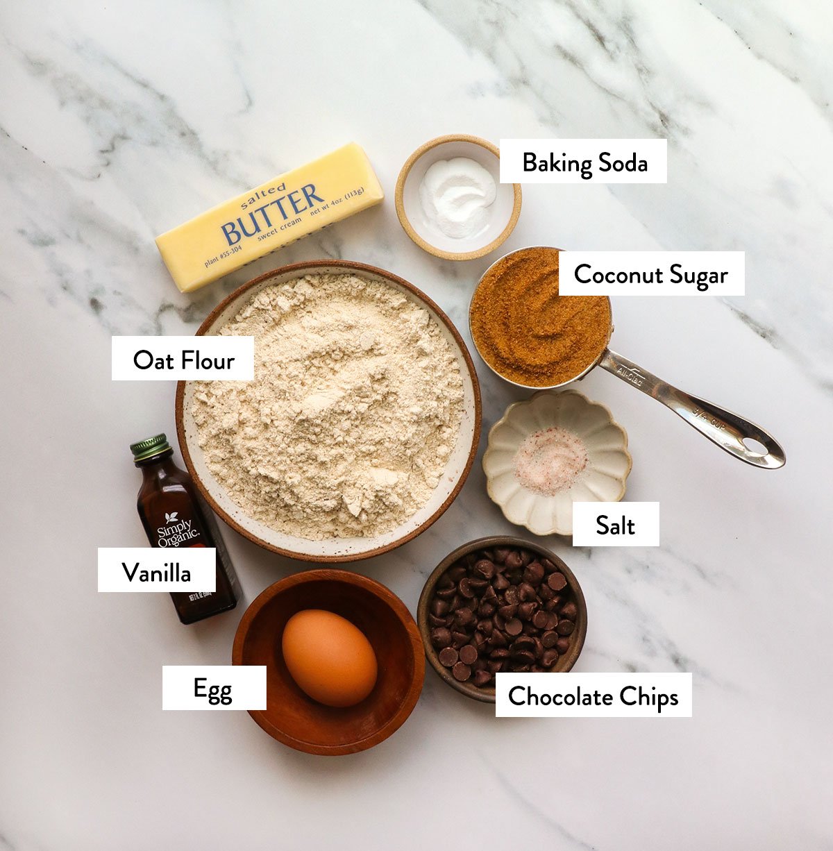 oat flour, coconut sugar, butter, egg, and chocolate chips labeled for white surface. 