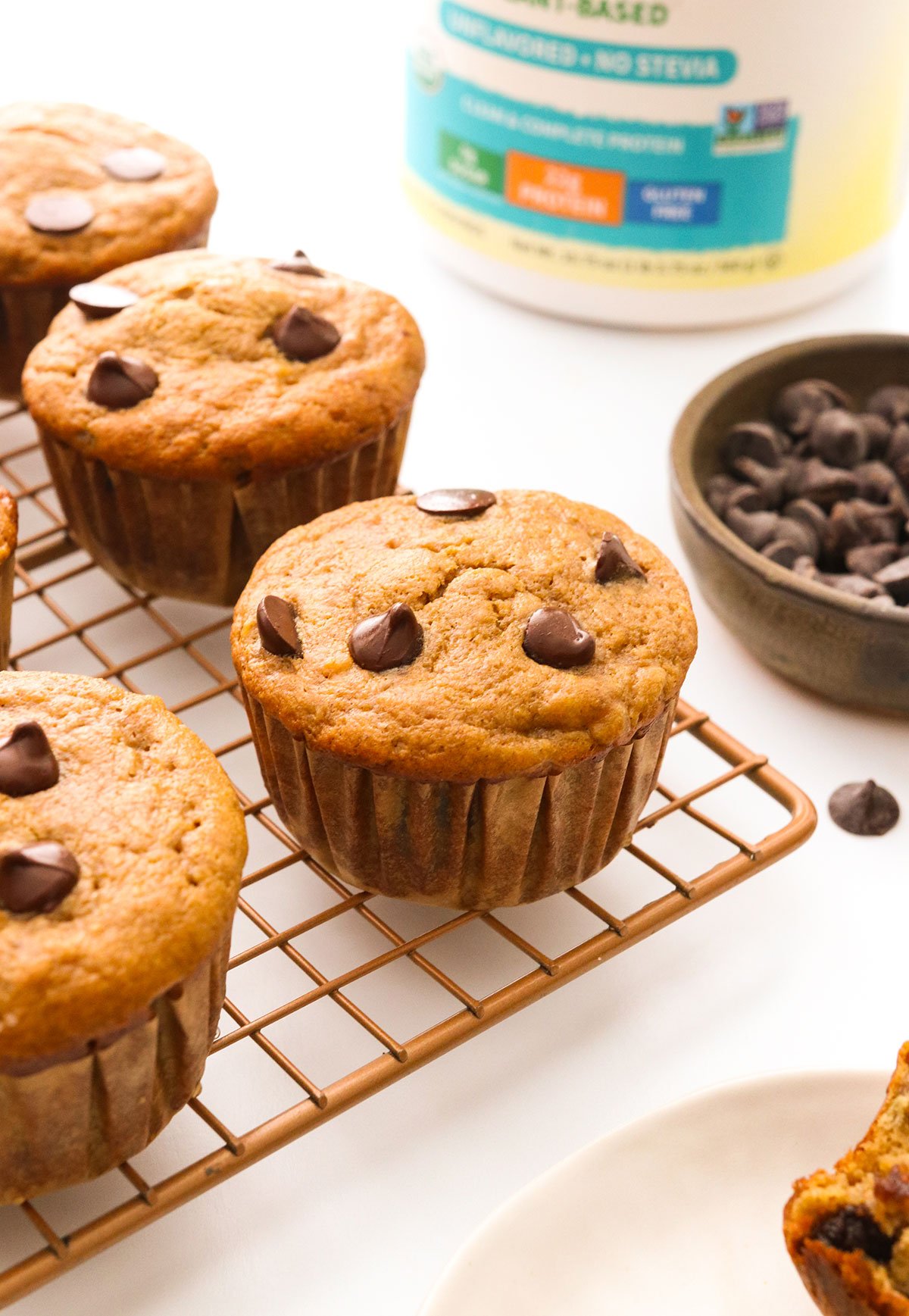 protein muffins on a cooling rack with chocolate chips.