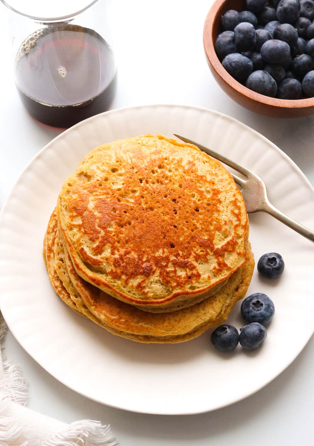 protein pancakes served plain on a white plate.