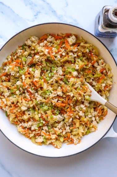 egg roll in a bowl with tofu in a large white skillet.