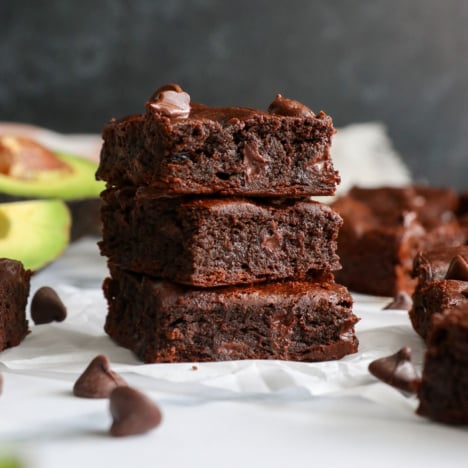 avocado brownies stacked with a black background.