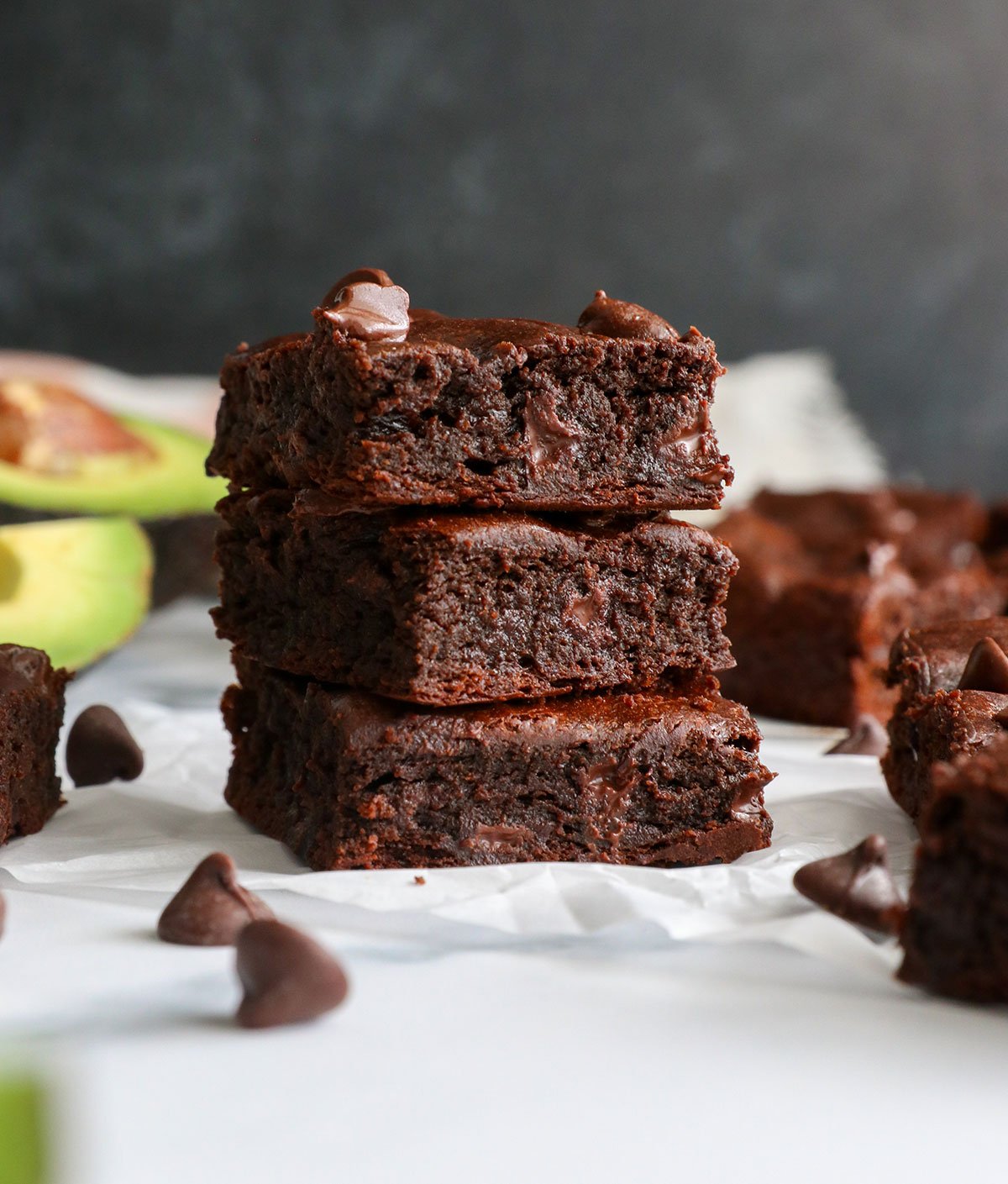 avocado brownies stacked with a black background. 