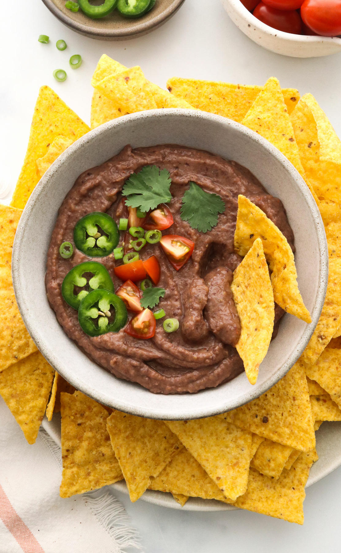 black bean dip served in a bowl with tortilla chips.