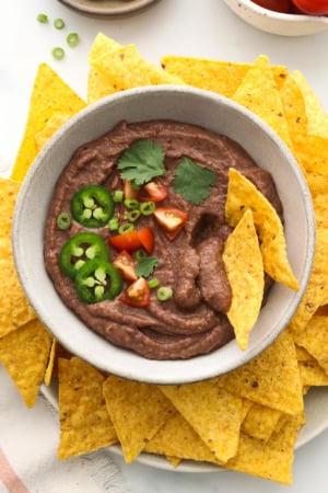 black bean dip served in a bowl with tortilla chips.